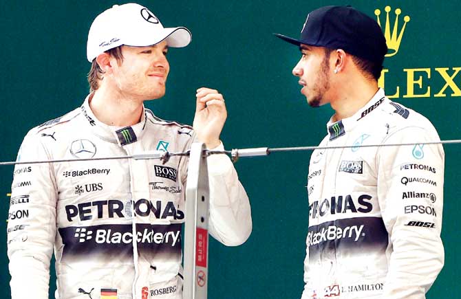 Lewis Hamilton (right) chats with Nico Rosberg.  Pic/AFP