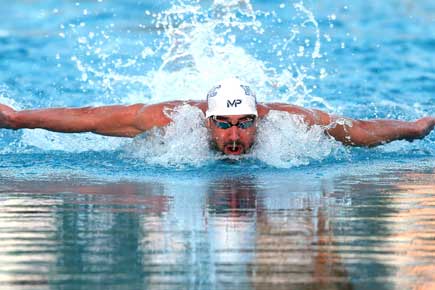 Michael Phelps wins 100m fly in racing return