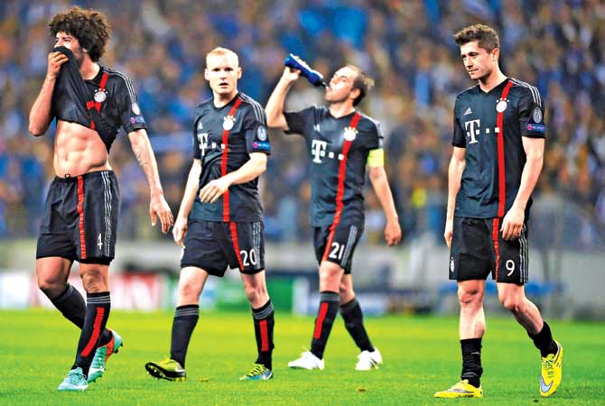 Beaten and Bruised: Bayern Munich’s Dante left, Sebastian Rode second from left, Philipp Lahm and Robert Lewandowski right look dejected after losing their first leg quarter-final against Porto at Estadio do Dragao on Wednesday. Pic/Getty Images