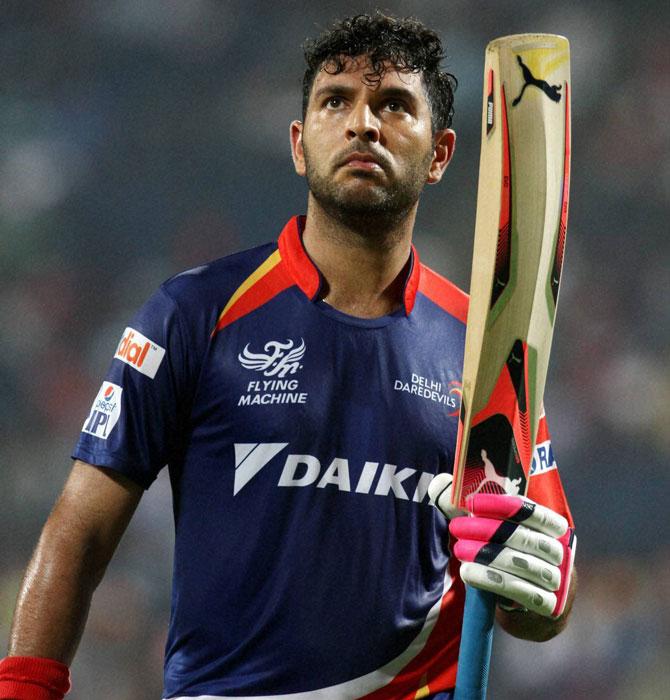 Delhi Daredevils player Yuvraj Singh raises his bat as he walks back to the pavilion after getting out during an IPL T20 match against Kings XI Punjab in Pune on Wednesday. Pic/PTI
