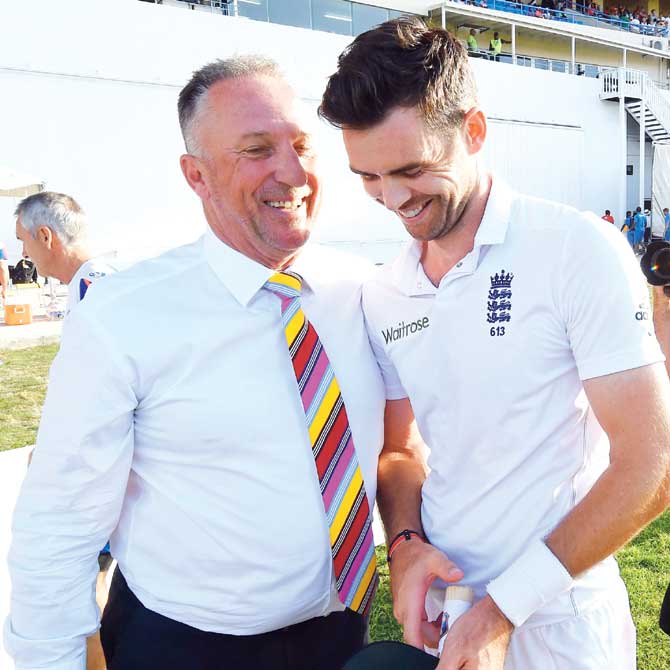 James Anderson (right) is greeted by Ian Botham after the England pacer surpassed his record to become the country