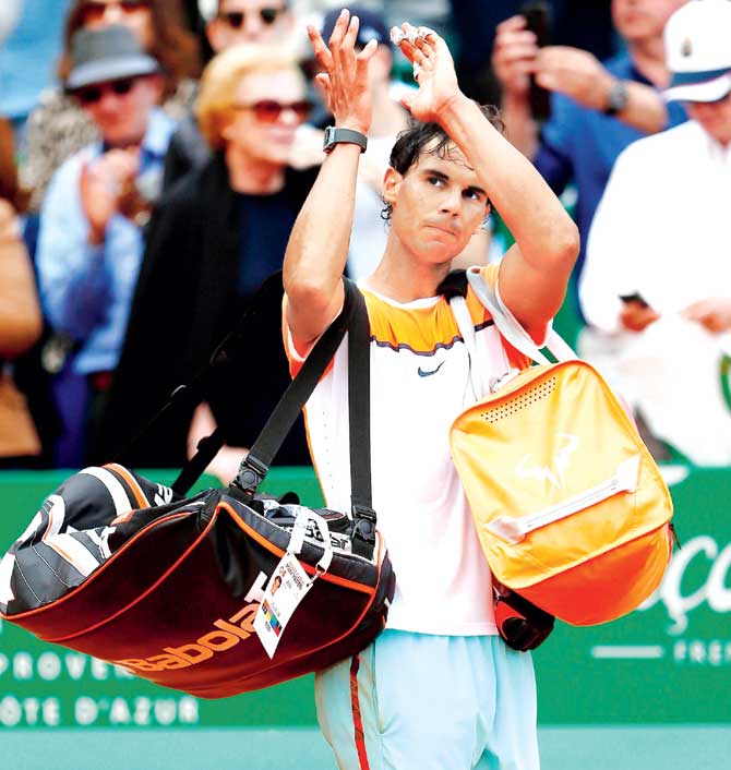 Rafael Nadal leaves the Monte-Carlo Sporting Club after his defeat on Saturday