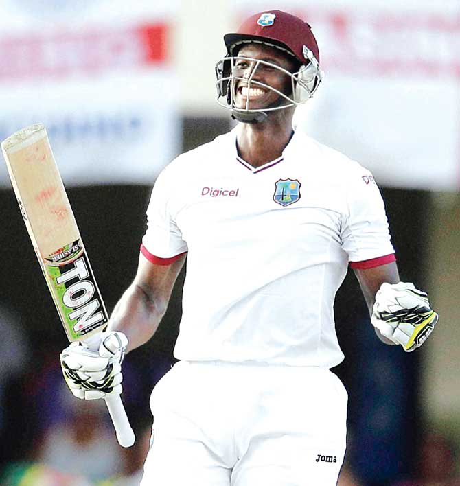 Jason Holder celebrates his century on Day Five on the first Test against England in Antigua on Friday. Pic:AP/PTI