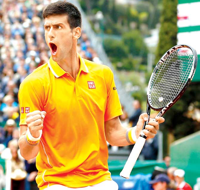 Novak Djokovic celebrates after winning a game against Tomas Berdych in their Monte Carlo Masters final yesterday at the Monte-Carlo Sporting Club.