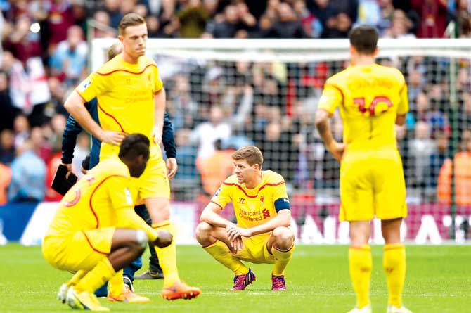 A dejected Steven Gerrard (centre) looks on after Liverpool’s semis loss against Aston Villa at Wembley Stadium. Pic/Getty Images
