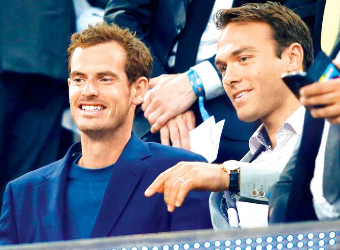 Andy Murray (left) and Ross Hutchins watch the Champions League tie between FC Barcelona and PSG