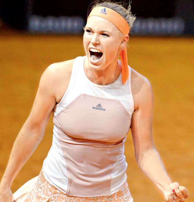 Caroline Wozniacki reacts after defeating Simona Halep. Pic/AFP