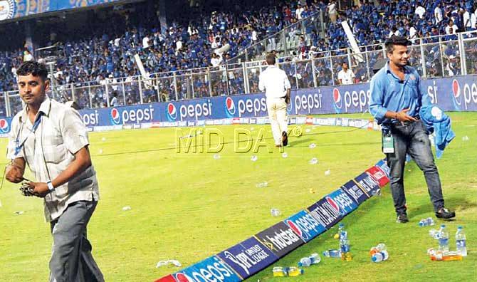 Volunteers left stunned after bottles were thrown from the stands. Pic/Suresh KK