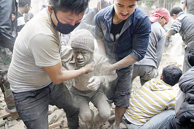 Rescue workers in Kathmandu carry an injured man to safety. PIC/AGENCIES