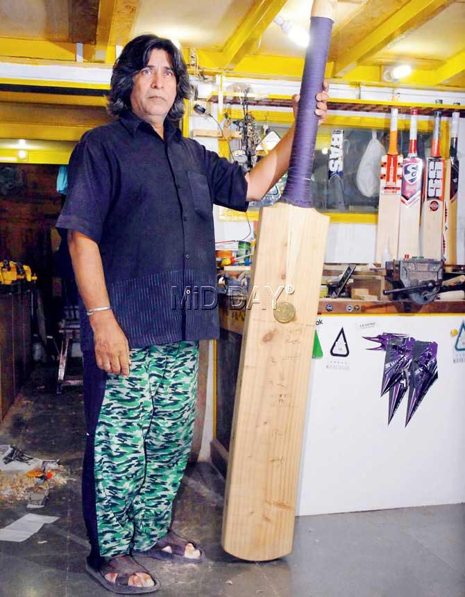 Aslam Chaudhary with the six-feet bat at his establishment in Dhobi Talao yesterday. Pic/Suresh KK