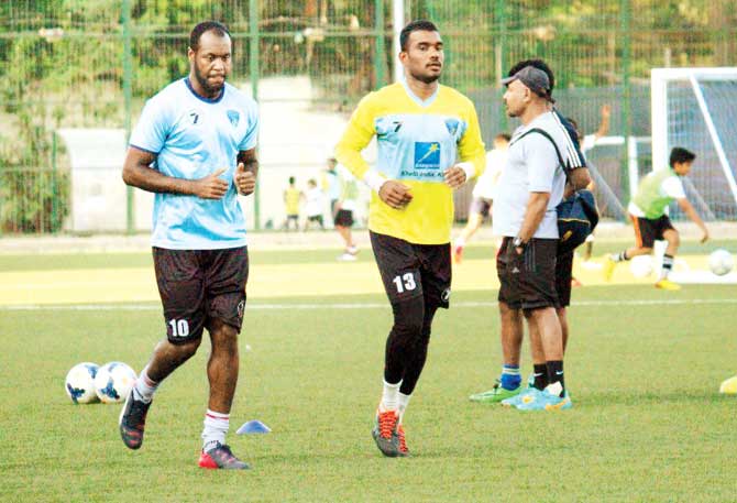 Mumbai FC players warm up during a practice session yesterday