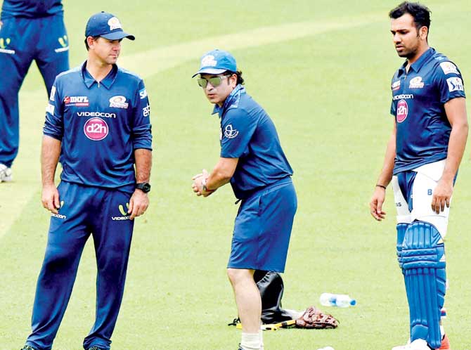 MI mentor Sachin Tendulkar demonstrates a shot as coach Ricky Ponting (left) and skipper Rohit Sharma (right) look on. Pic/PTI