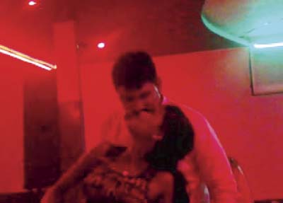 Grabs from one of the video clips sent to high-ranking Thane police officials, wherein Mulani can be seen mingling with a bar girl, while Babbar can be seen dancing and kissing the same bar girl. A police official claimed Indraprastha is a controversial bar and has been raided several times in the past