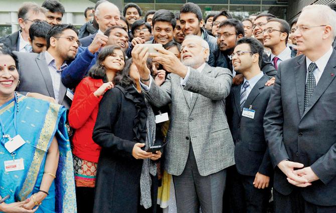 Prime Minister Narendra Modi takes a selfie with Indian employees during a visit to the Airbus facility in Toulouse, France