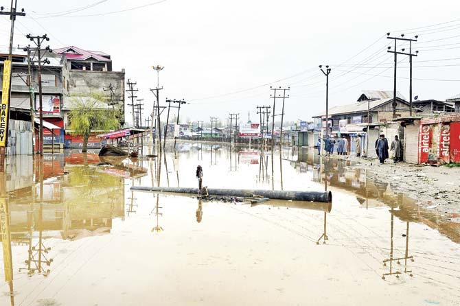 At the back of our heads we will recall the slow waters of Kashmir raising, rising, as the nearby mountains melt helplessly and submerge a city already awash with tears. Pic/AFP