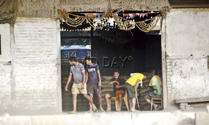 Workers at a Mumbai Port Trust cement warehouse at Wadi Bunder working without safety gear
