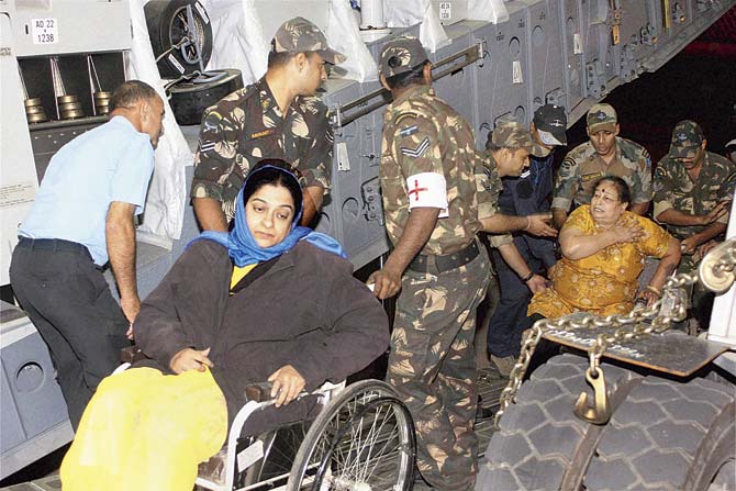 Indians evacuated from Nepal deboard a C-17 Globemaster- III of the Indian Air Force at Air Force Station Palam, New Delhi