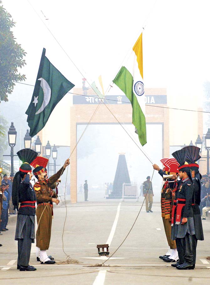 Pakistani and Indian soldiers lower their national flags at the border near Lahore. If people-to-people contact through liberal visa policies could be encouraged, Indians and Pakistanis would be able to travel to each other’s countries and see for themselves what lies across the border(s). That would break many a stereotype. Pic/Getty Images
