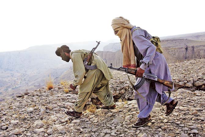 Marri tribal guerrillas prepare to attack a Pakistani troop outpost near Kahan in the Pakistani province of Balochistan in 2006. The Marri and Bugti tribes say that the Pakistani government takes their region