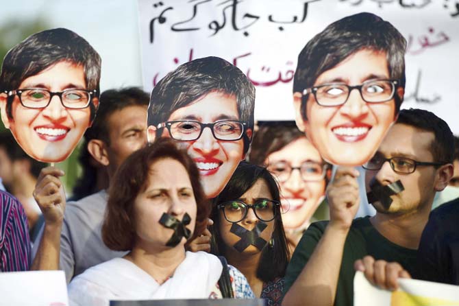 Pakistani activists hold up pictures of rights campaigner, Sabeen Mahmud, who was gunned down in her car minutes after she had hosted a seminar on abuses in the restive Balochistan province. Pic/AFP