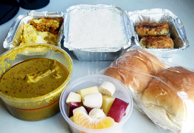 (Clockwise from left) Green Mutton Curry, Sali Par Eddu, Plain Rice, Potato Cheese Cutlet, pav and fruits. pic/Romita Chakroborty