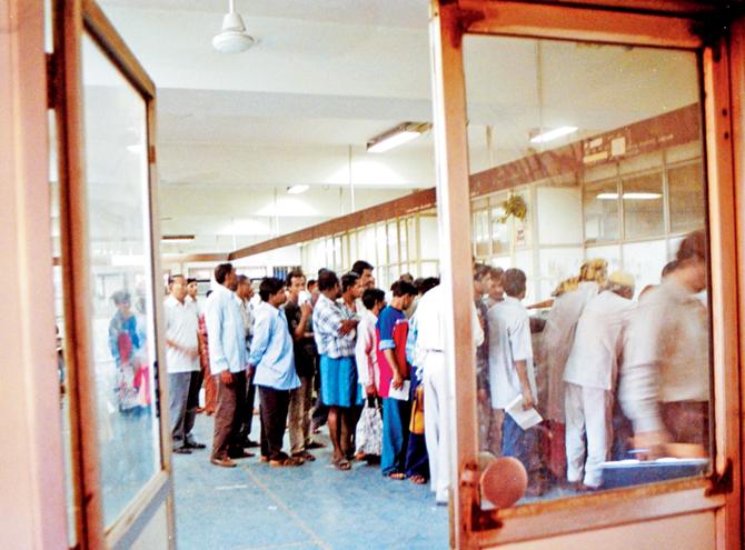 People queue up at the money order counter of the Dadar post office. 