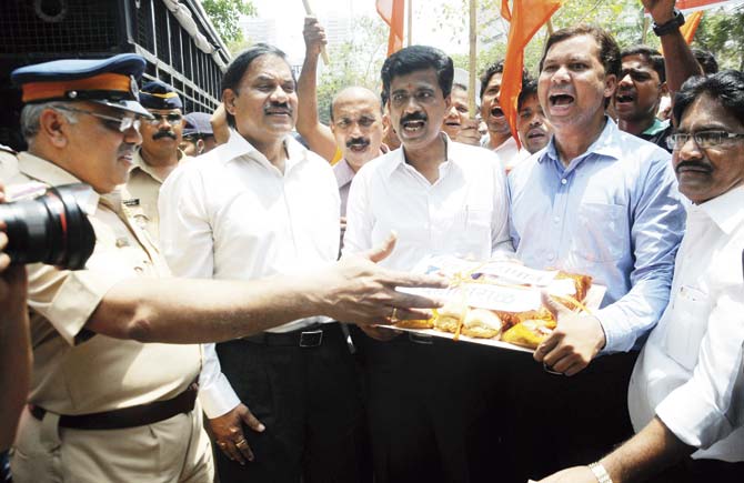 Shiv Sena workers protested outside author Shobhaa De’s house, offering her vada pav and dahi misal after De mockingly said the dishes would replace popcorn in multiplexes. Pics/Satyajit Desai