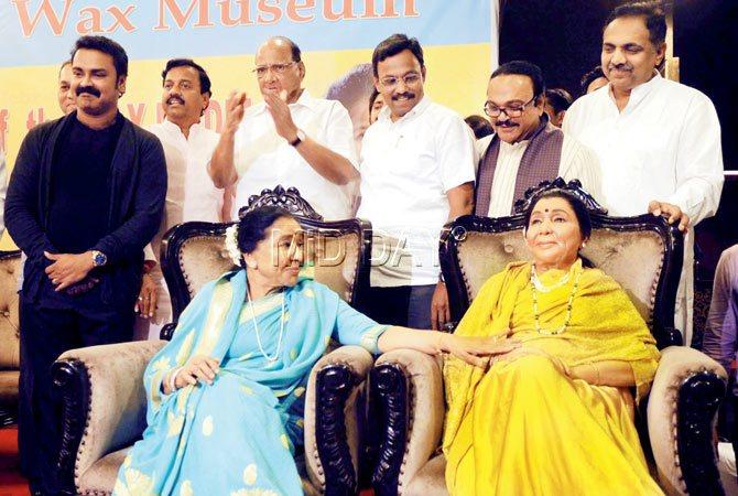 Asha Bhosle (L) seated next to her wax statue