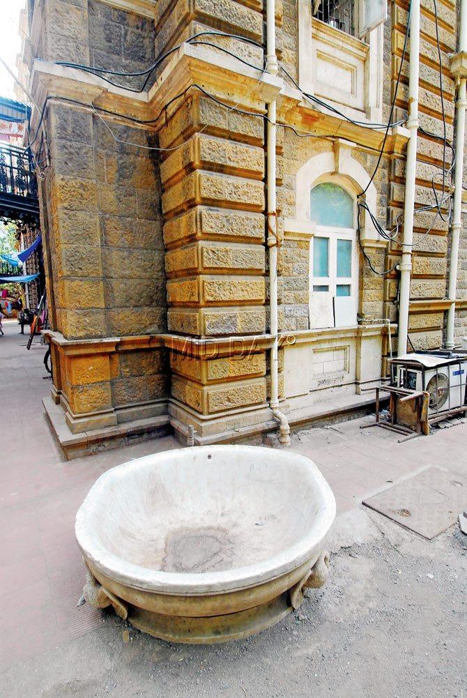 A large marble water bowl meant for horses stands a reminder of another time.