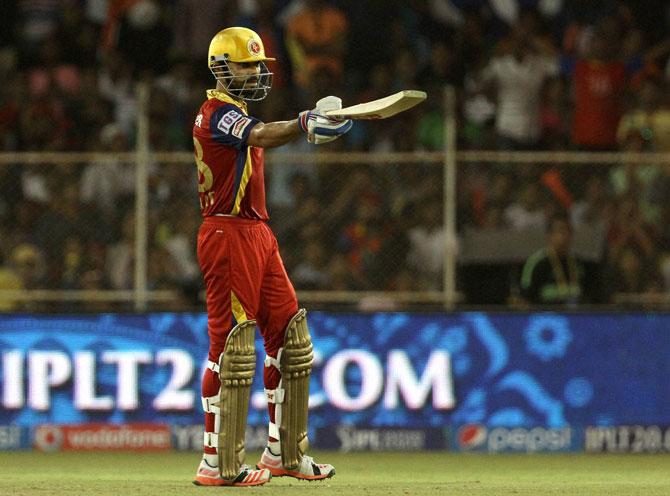 Royal Challengers Bangalore captain Virat Kohli raises his bat after scoring a fifty against Rajasthan Royals during an IPL match against in Ahmedabad on Friday.