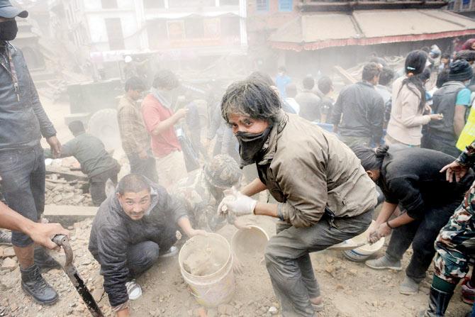 People clear rubble in Kathmandu’s Durbar Square, a UNESCO World Heritage Site that was severely damaged.  pic/ AFP