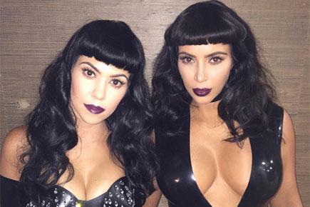 Kim and Kourtney Kardashian flaunt cleavage-baring suits