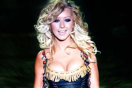Christina Aguilera poses topless