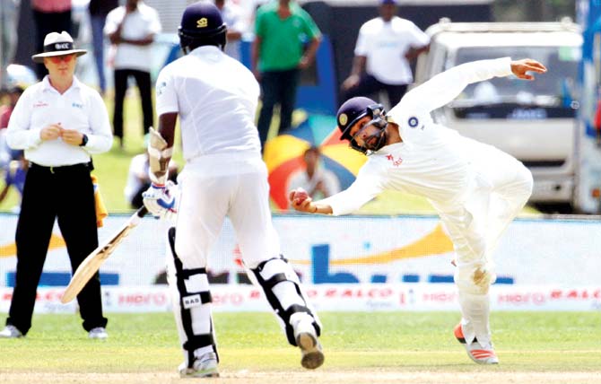 Rohit Sharma takes an acrobatic catch to dismiss Sri Lankan skipper Angelo Mathews for 64 yesterday. Pic/Solaris Images