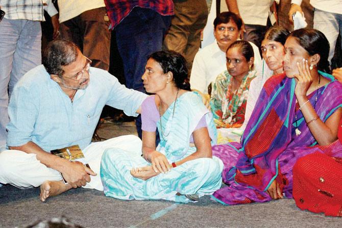 Nana Patekar interacts with widows of farmers who committed suicide in the Vidarbha region at an event in Nagpur on August 10. Pic/PTI 