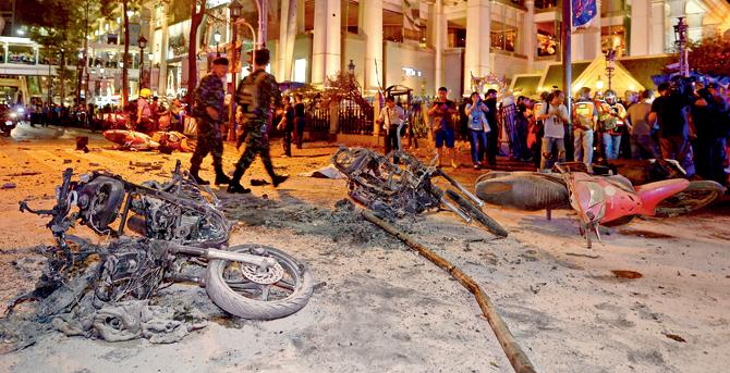 Several motorcycles parked on the road were destroyed in the blasts. Seen here are two motorcycles and one fallen pole; according to the police, the bombs were strapped to a utility pole and a motorbike. PIC/AFP