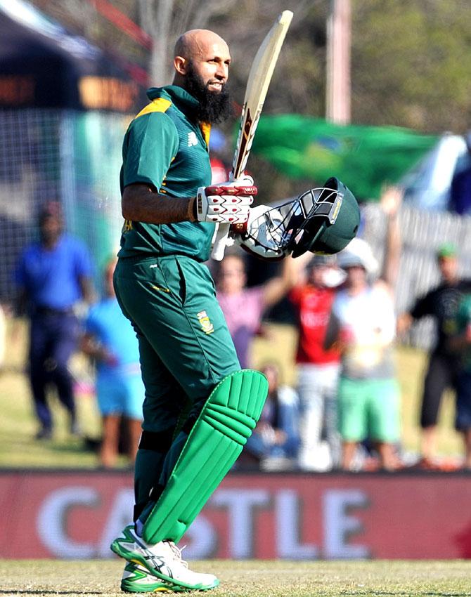 South African batsman Hashim Amla raises his bat and helmet as he celebrates scoring a century (100 runs) during the first One Day International match between South Africa and New Zealand in Centurion. Pic/AFP