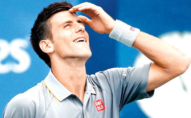 Novak Djokovic reacts during a rain delay in his match. Pic/AFP
