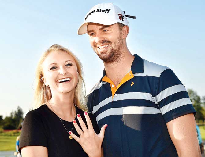 Louise De Fries shows her ring while posing with Harto. Pic/Getty Images
