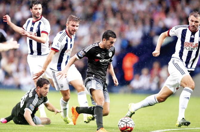 Chelsea’s Pedro Rodriguez (second from right) gets past a couple of West Bromwich Albion defenders before scoring the opening goal during their English Premier League match at the Hawthorns in West Bromwich, England yesterday. pic/afp