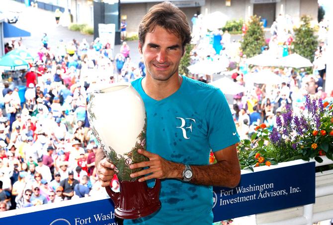Roger Federer of Switzerland poses with the trophy after defeating Novak Djokovic of Serbia to win the mens singles final at the Western & Southern Open at the Linder Family Tennis Center in Cincinnati. Pic/AFP