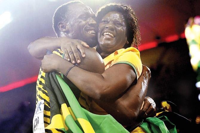 Usain Bolt hugs his mother Jennifer after winning the 100m event