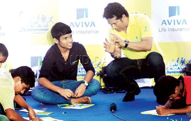 Sachin Tendulkar interacts with a kid at an event at Wadala