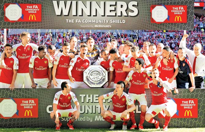 The Arsenal team celebrates with the Community Shield at Wembley in London yesterday. Pics/AFP