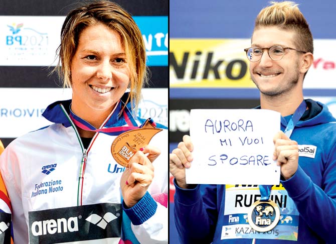 Italy-s Simone Ruffini holds a sign for his girlfriend Aurora Ponsale left in Italian that reads "Aurora will you marry me?" as he stands atop the victory podium after winning gold in the 25km open water event at the FINA World Swimming championships in Kazan, Russia recently. Pics/AFP, Getty Images 
