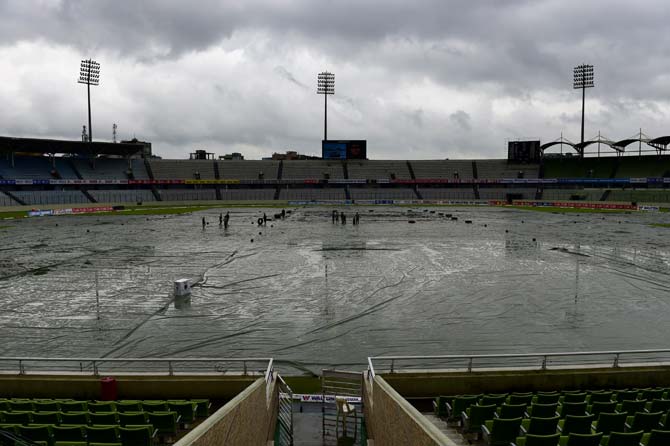 A general view shows workers on the field as rain delayed the third day of the second cricket Test match between Bangladesh and South Africa at the Sher-e-Bangla National Cricket Stadium in Dhaka. Pic/AFP