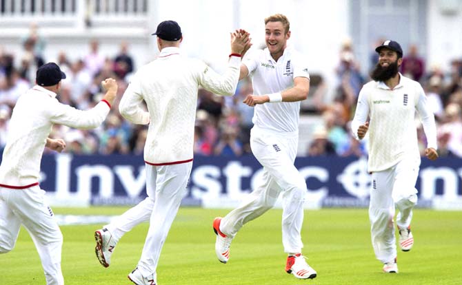 England-s Stuart Broad, centre right, celebrates with teammates after taking the wicket of Australia-s Michael Clarke, caught by Alastair Cook for 10, on the first day of the fourth Ashes test cricket match between England and Australia at Trent Bridge cricket ground in Nottingham. Pic: AP/PTI