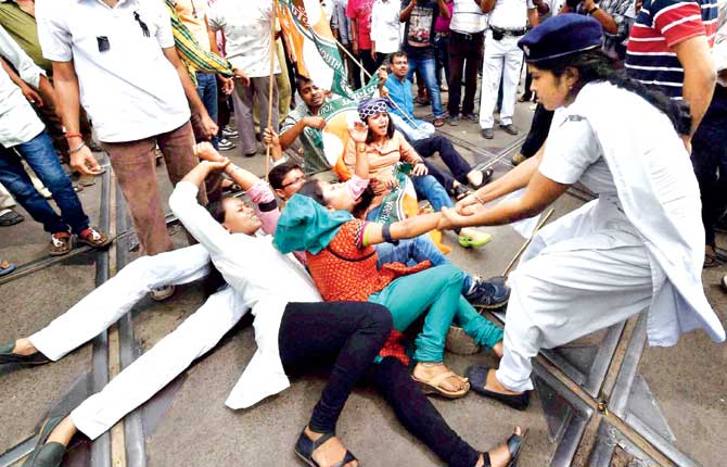 Police detain Chhatra Parishad activists during their agitation and road blockade programme in Kolkata on Saturday. Pic/PTI