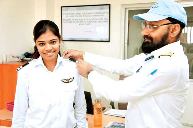 A chief flight instructor honours Swari Ladre with Two Stripes at the National Flying Training Institute in Gondia