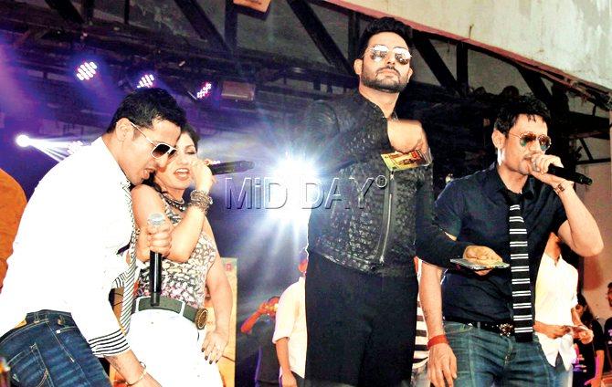 Abhishek Bachchan (second from right) promotes an upcoming film along with Manmeet Singh (left), Tulsi Kumar and Harmeet Singh (right) at a college festival.